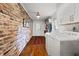 Functional laundry room with exposed brick, white cabinetry, and ample counter space for convenience at 302 Chinquapin Sw Dr, Marietta, GA 30064