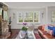 Cozy living room featuring a brick fireplace, bay window, and stylish decor at 302 Chinquapin Sw Dr, Marietta, GA 30064