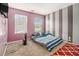 Bedroom with striped accent wall, carpet, and two windows for natural light at 474 Boxelder Rd, Atlanta, GA 30349