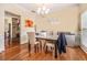 Formal dining room featuring hardwood floors, elegant lighting, and space for Gathering gatherings at 474 Boxelder Rd, Atlanta, GA 30349