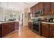 A modern kitchen features stainless steel appliances, dark wood cabinets and hardwood flooring at 474 Boxelder Rd, Atlanta, GA 30349
