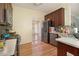 A kitchen with stainless appliances, hardwood flooring, and dark cabinets at 474 Boxelder Rd, Atlanta, GA 30349