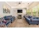 Comfortable living room with plush sofas, a fireplace, and large windows providing ample natural light at 474 Boxelder Rd, Atlanta, GA 30349