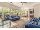Cozy living area with plush seating, large windows, and an open layout flowing into the dining space at 474 Boxelder Rd, Atlanta, GA 30349