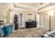 Main bedroom with tray ceiling, neutral carpet, natural light, and ceiling fan at 474 Boxelder Rd, Atlanta, GA 30349