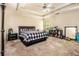 Spacious main bedroom with tray ceilings, neutral carpet, and ceiling fan at 474 Boxelder Rd, Atlanta, GA 30349