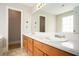 Bathroom featuring double sinks, a vanity with cabinets, and a large mirror, creating an elegant space at 75 Plantation Ln, Locust Grove, GA 30248