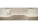 Close-up of a soaking tub with tiled surround and updated faucet fixtures, ideal for relaxation at 75 Plantation Ln, Locust Grove, GA 30248