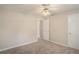 Neutral bedroom featuring plush carpet, a ceiling fan, and ample natural light at 75 Plantation Ln, Locust Grove, GA 30248