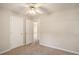 Bedroom featuring neutral decor, plush carpeting, and a connecting door, creating a seamless flow at 75 Plantation Ln, Locust Grove, GA 30248