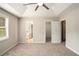 Comfortable bedroom with neutral walls, plush carpeting, and multiple doorways leading to closet and bath at 75 Plantation Ln, Locust Grove, GA 30248