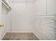 Walk-in closet with white shelving and hanging rods, providing ample storage and organization at 75 Plantation Ln, Locust Grove, GA 30248