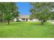 Traditional single-story house offers a spacious front yard and a serene setting at 75 Plantation Ln, Locust Grove, GA 30248