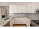 Charming kitchen features ample counter space, classic cabinets, and tiled backsplash at 75 Plantation Ln, Locust Grove, GA 30248