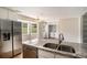 Kitchen features granite counters, stainless appliances and access to laundry room at 75 Plantation Ln, Locust Grove, GA 30248