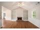 Bright living room with hardwood floors, fireplace, and built-in bookshelves at 75 Plantation Ln, Locust Grove, GA 30248