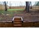 Private backyard featuring a wooden retaining wall, steps, mature trees, and ample space for outdoor activities at 1122 Rice Nw St, Atlanta, GA 30318