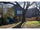 View of backyard with lawn, privacy fence, wooden porch, and modern siding at 1122 Rice Nw St, Atlanta, GA 30318