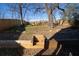 Secluded backyard featuring wooden retaining wall, steps, mature trees, and plenty of room for outdoor enjoyment at 1122 Rice Nw St, Atlanta, GA 30318