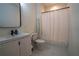 Clean bathroom featuring a vanity, toilet, and shower/tub combination at 1122 Rice Nw St, Atlanta, GA 30318
