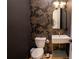Chic powder room with patterned wallpaper, designer fixtures, and a modern sink at 1122 Rice Nw St, Atlanta, GA 30318