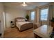 Cozy bedroom with natural light, a plush bed, and a dedicated desk area at 1122 Rice Nw St, Atlanta, GA 30318