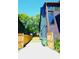 A long driveway with wooden fences and a view of the side of the house at 1122 Rice Nw St, Atlanta, GA 30318