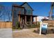 Charming two-story home with a brick facade, wooden accents, and a covered front porch at 1122 Rice Nw St, Atlanta, GA 30318