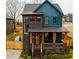 Beautiful two-story home showcasing a front porch, brick accents, and well-maintained landscaping, creating an inviting appeal at 1122 Rice Nw St, Atlanta, GA 30318