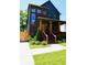 Charming two-story home featuring dark brick, wood trim, and a welcoming front porch at 1122 Rice Nw St, Atlanta, GA 30318