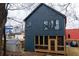 Modern two-story home with stylish blue siding, a cozy screened porch, a storage shed, and a well-maintained yard at 1122 Rice Nw St, Atlanta, GA 30318