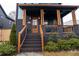 Charming front entrance showcasing a brick stairway, wooden porch supports, and professional landscaping, perfect for curb appeal at 1122 Rice Nw St, Atlanta, GA 30318