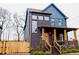 Inviting two-story home featuring a welcoming front porch, brick accents, and well-maintained landscaping for curb appeal at 1122 Rice Nw St, Atlanta, GA 30318