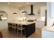 Modern kitchen features an island with seating, stainless steel appliances, and custom cabinets at 1122 Rice Nw St, Atlanta, GA 30318