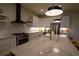 Modern kitchen with a large marble island, stainless steel appliances, and sleek white cabinetry at 1122 Rice Nw St, Atlanta, GA 30318