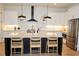 Well-appointed kitchen with stainless steel appliances, large island, and modern black pendant lights at 1122 Rice Nw St, Atlanta, GA 30318