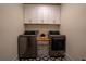 Laundry room with front-load washer and dryer plus upper cabinets at 1122 Rice Nw St, Atlanta, GA 30318