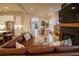 Bright open-concept living room featuring a fireplace, wood floors, and comfortable brown leather sofa at 1122 Rice Nw St, Atlanta, GA 30318
