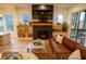Living room features a fireplace, floating shelves, hardwood floors, and a comfortable leather sofa at 1122 Rice Nw St, Atlanta, GA 30318
