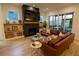 Beautiful living room features a fireplace, floating shelves, hardwood floors, and a leather sofa at 1122 Rice Nw St, Atlanta, GA 30318