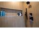 Shower with tiled walls, rainfall showerhead, and built-in shelving at 1122 Rice Nw St, Atlanta, GA 30318