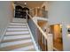 Bright staircase with wooden treads, black iron railings, and contemporary lighting at 1122 Rice Nw St, Atlanta, GA 30318