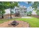 Expansive backyard featuring a large grassy area, a basketball court, and a fire pit at 1547 Trilogy Park, Hoschton, GA 30548
