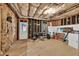 Unfinished basement area with exposed insulation, wood frame walls, and door to the outside at 1547 Trilogy Park, Hoschton, GA 30548