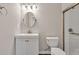 Well-lit bathroom featuring modern vanity, toilet, and updated shower with glass door at 1547 Trilogy Park, Hoschton, GA 30548