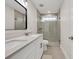 Bathroom featuring a double vanity, a glass shower, and tile flooring at 1547 Trilogy Park, Hoschton, GA 30548