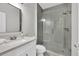 Modern bathroom with glass shower, vanity, and neutral colors at 1547 Trilogy Park, Hoschton, GA 30548