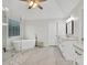 Bright bathroom featuring a soaking tub, a glass enclosed shower, and marble floors at 1547 Trilogy Park, Hoschton, GA 30548
