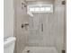 Close up of a shower with glass doors and gray tile at 1547 Trilogy Park, Hoschton, GA 30548