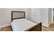 Bedroom with a bed, hardwood floors, neutral walls, and a double closet at 1547 Trilogy Park, Hoschton, GA 30548